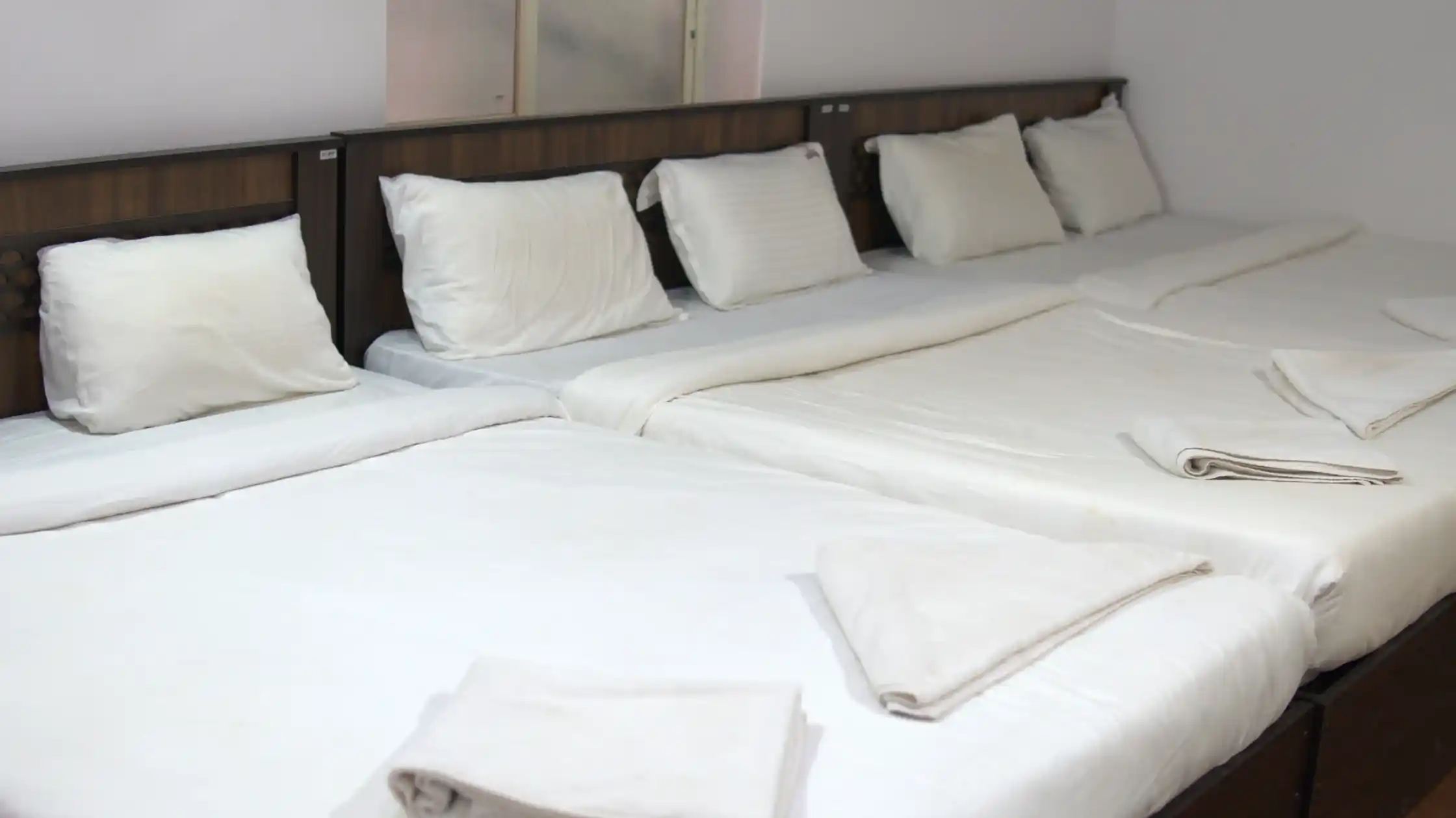 Resort bedroom prepared for guests attending a destination wedding in Sakleshpur.